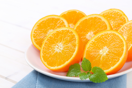plate of halved oranges on blue place mat - close upの写真素材