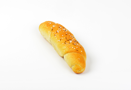 fresh roll with salt and caraway seeds on white background