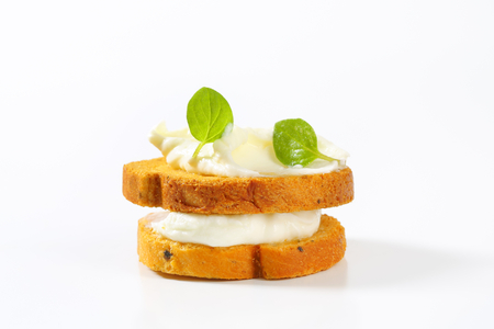 Small round toast with cheese spreadの写真素材