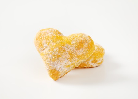 two heart shaped cookies on white background