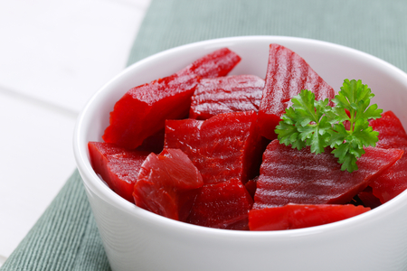 bowl of sliced and pickled beetroot on grey place mat - close upの写真素材