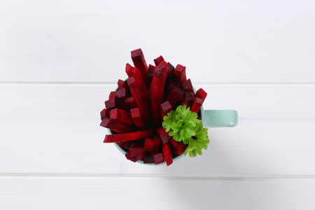 cup of beetroot strips on white wooden backgroundの写真素材
