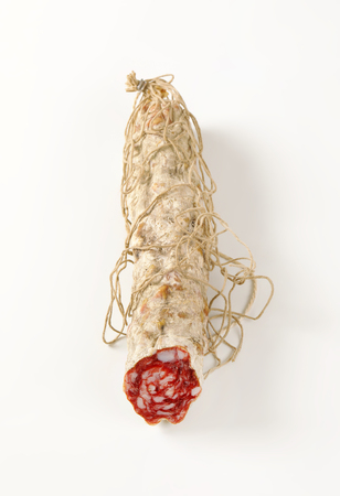Dry cured pork sausage on white backgroundの写真素材