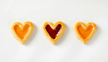 Heart shaped shortbread cookies with apricot and cherry jam fillingの写真素材