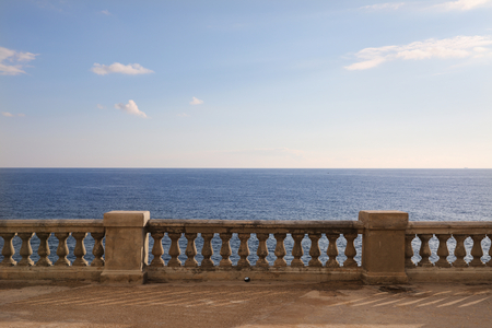 View from a terrace with old stone balustrade overlooking the seaの写真素材