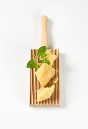 parmesan cheese and oregano on wooden graterの写真素材