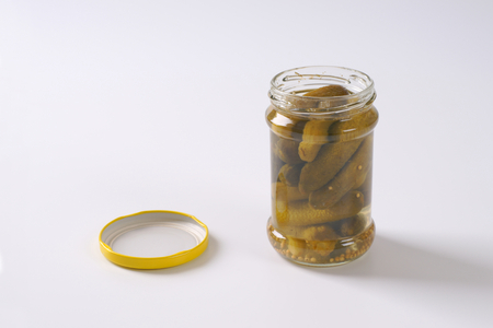jar of pickled cucumbers on white backgroundの写真素材