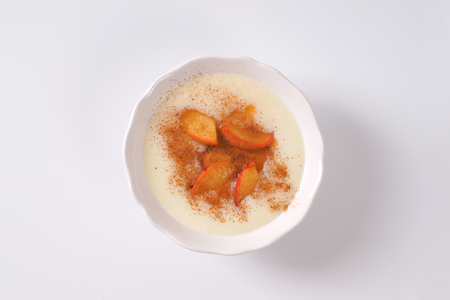 bowl of semolina pudding with apples and cinnamonの写真素材