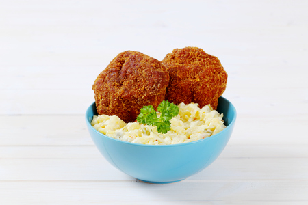 burgers with potato salad in turquoise bowlの写真素材