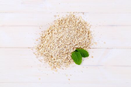 pile of rolled oats on white backgroundの写真素材