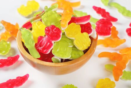 bowl of colorful gummy candies in the shape of animalsの写真素材