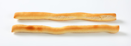 two crispy bread sticks on white background
