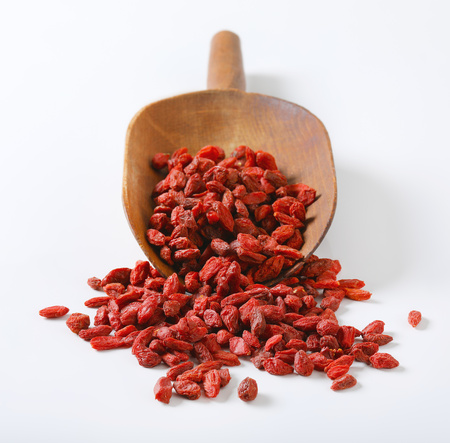scoop of healthy goji berries on white backgroundの写真素材
