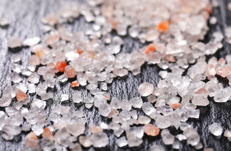 crystals of coarse grained Himalayan salt on black slate