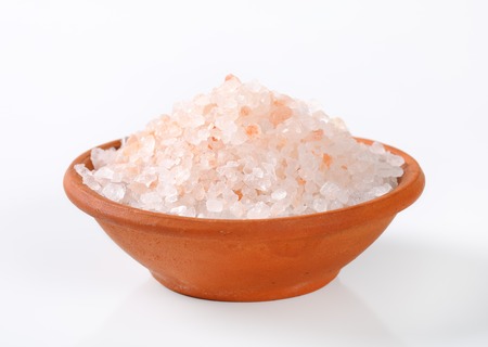bowl of coarse grained Himalayan salt on white backgroundの写真素材