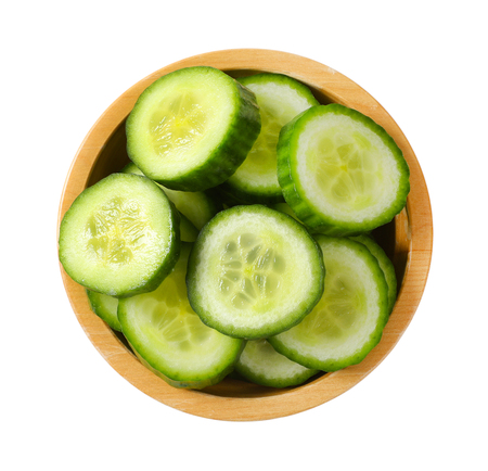 bowl of sliced cucumber on white backgroundの写真素材