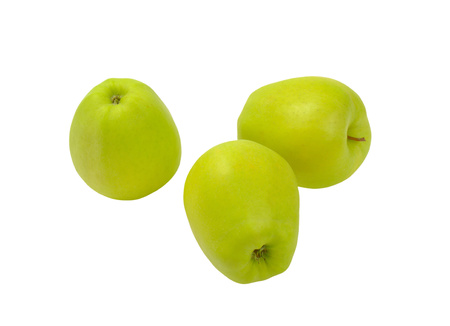 Three green apples on white wooden  backgroundの写真素材