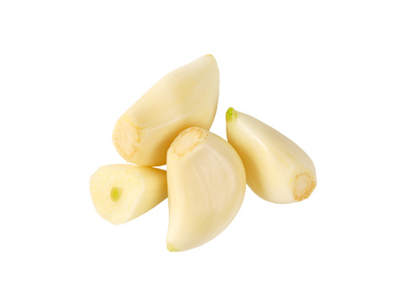 peeled cloves of fresh garlic on white backgroundの写真素材
