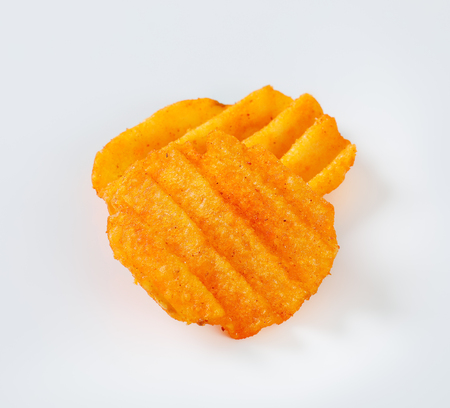 fried potato chips on white backgroundの写真素材