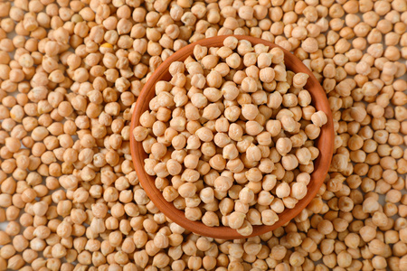 bowl of raw chickpeas on chickpeas backgroundの写真素材