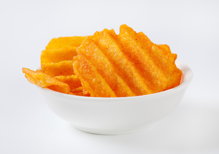 bowl of fried potato chips on white backgroundの写真素材