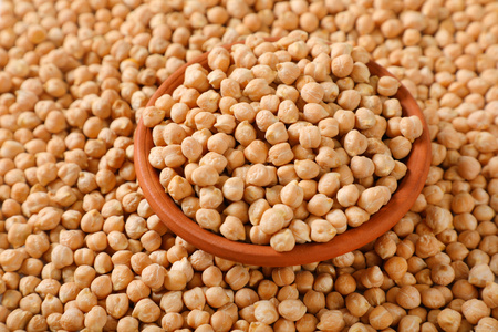 bowl of raw chickpeas on chickpeas backgroundの写真素材
