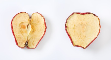 two dried apple slices on white backgroundの写真素材