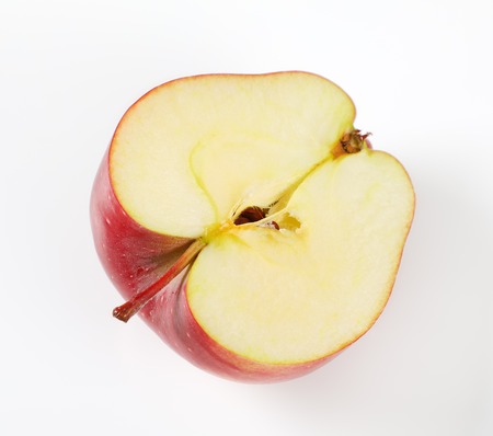 half of red apple on white backgroundの写真素材