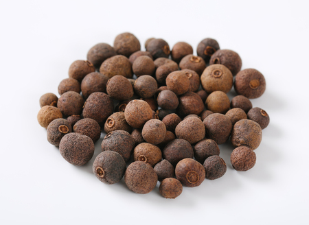 pile of whole allspice berries on white backgroundの写真素材