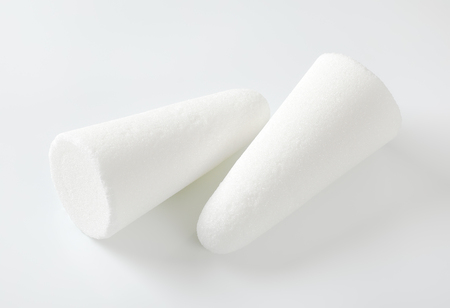 two white sugar loaves or cones on white backgroundの写真素材