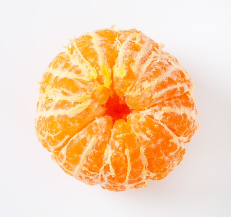 peeled ripe tangerine on white backgroundの写真素材