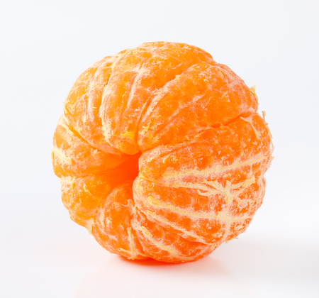 peeled ripe tangerine on white backgroundの写真素材