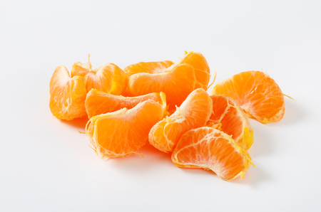 slices of fresh tangerine on white backgroundの写真素材
