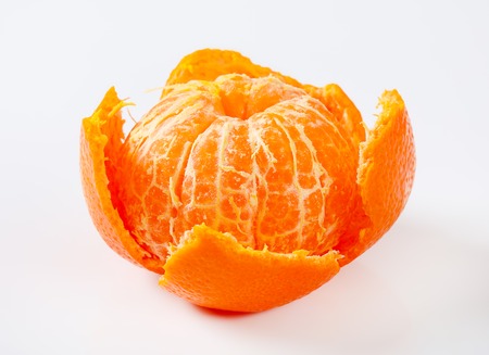 peeled ripe tangerine on white backgroundの写真素材
