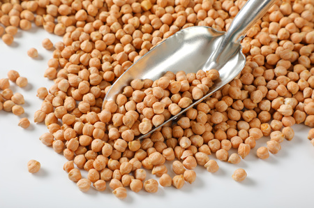 raw dried chickpeas and metal scoopの写真素材