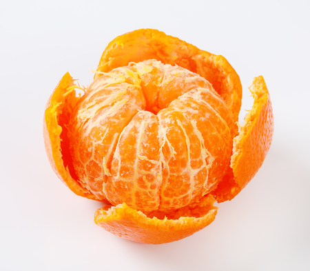 peeled ripe tangerine on white backgroundの写真素材
