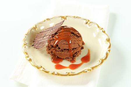 Scoop of chocolate ice cream with toffee sauceの写真素材