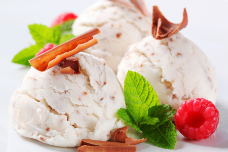 Scoops of stracciatella ice cream topped with chocolate shavingsの写真素材