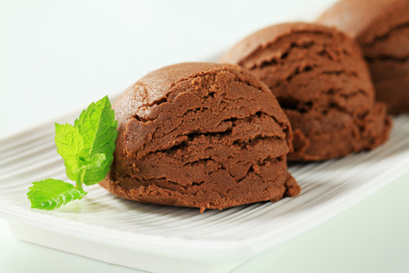 Scoops of chocolate almond ice cream on plateの写真素材