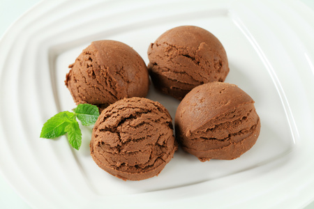 Scoops of chocolate almond ice cream on plateの写真素材