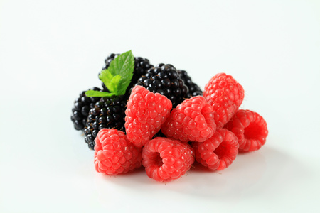 Studio shot of fresh raspberries and blackberriesの写真素材