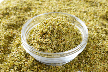 Dried Marjoram leaves in a glass bowlの写真素材
