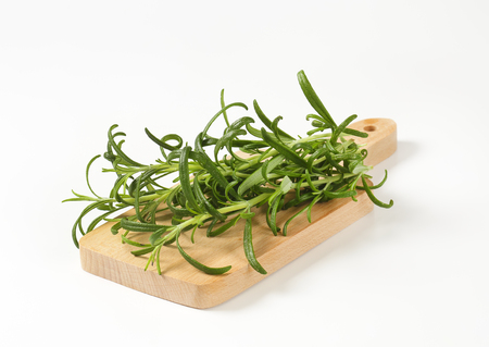 Fresh rosemary sprigs on cutting boardの写真素材