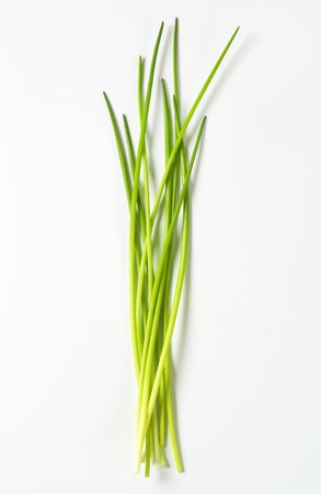 Fresh chives leaves on white backgroundの写真素材