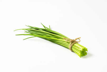 Bunch of fresh chives on white backgroundの写真素材