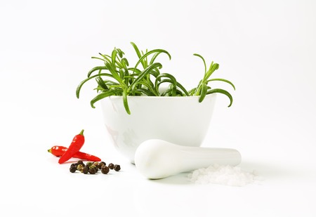 Fresh rosemary in a porcelain mortarの写真素材