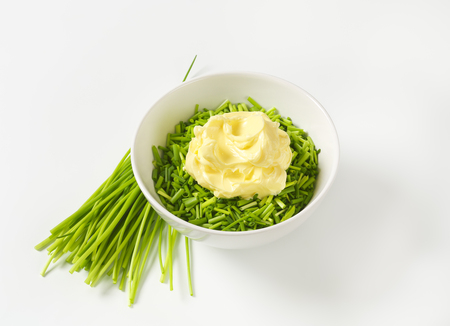 Chopped chives and butter in a bowlの写真素材