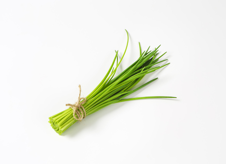 Bunch of fresh chives on white backgroundの写真素材