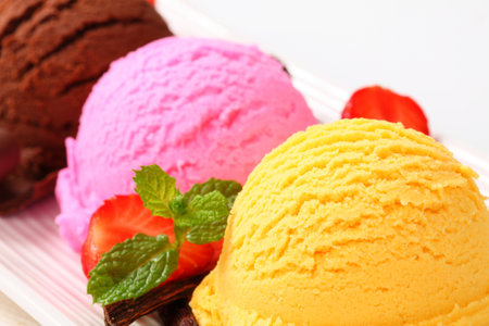 Three scoops of ice cream (yellow, brown, pink)