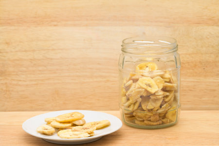 Organic food in the zero-waste store. Food storage in the kitchen for a low-waste lifestyle. Dried bananas in glass jars. Environmentally friendly shopping in a plastic-free grocery store.の写真素材